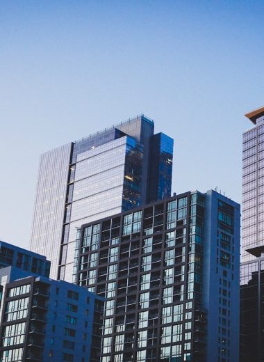 white and blue glass walled high rise building